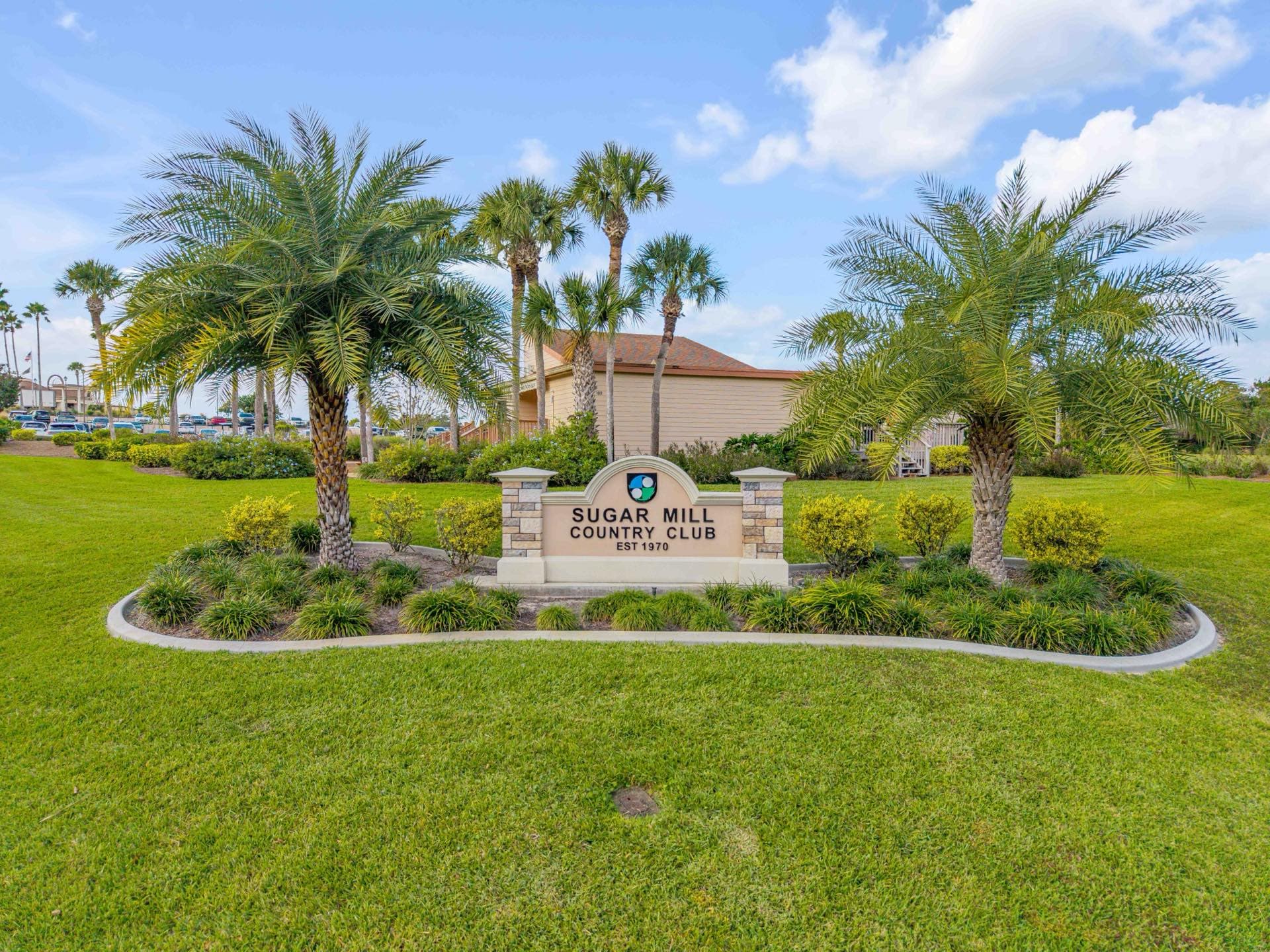 Sugar Mill Country Club golf course with palm trees and homes in New Smyrna Beach