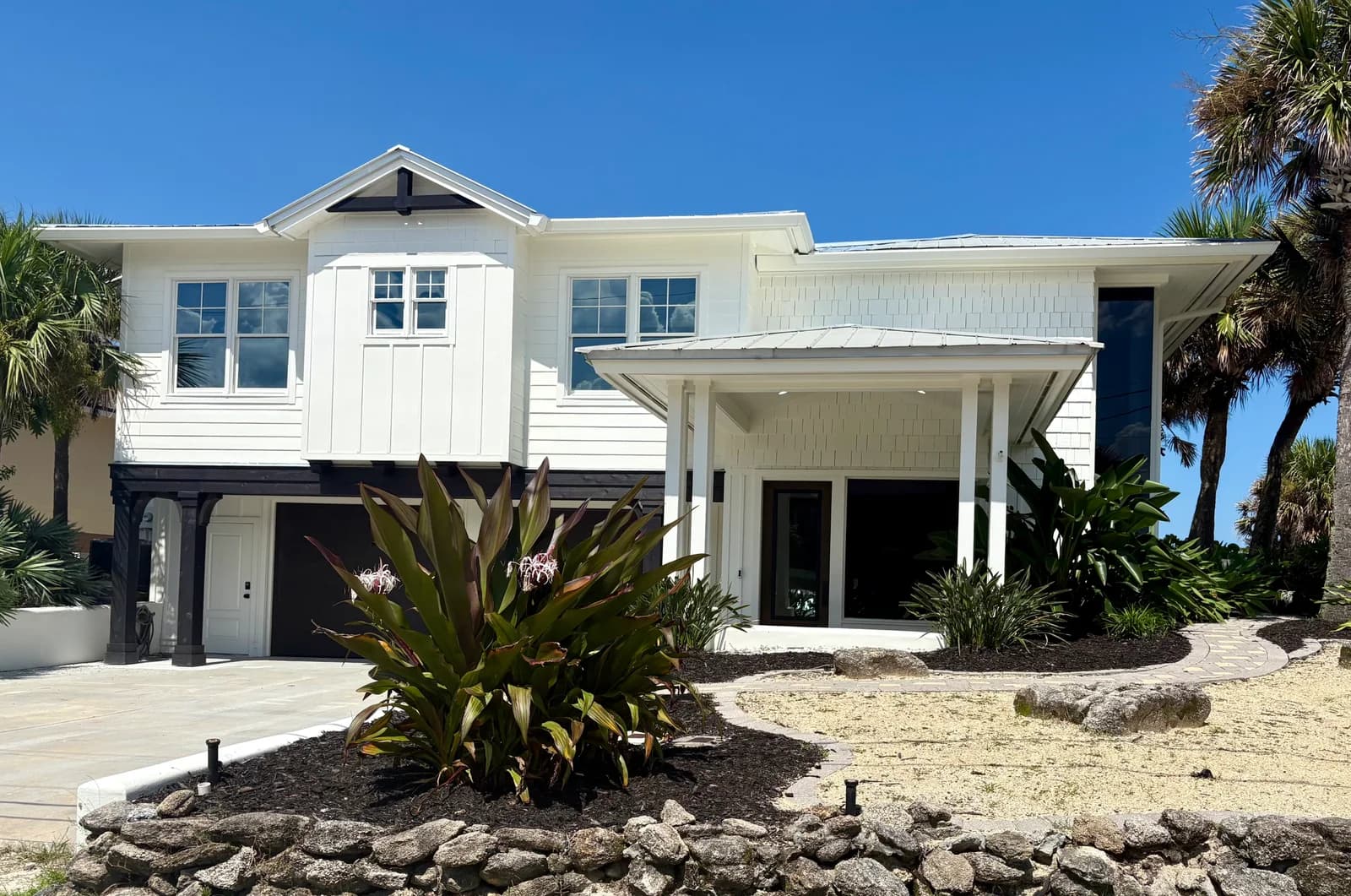 Street-facing elevation of 3111 Hill Street, showing the gabled second storey, covered entry and garage doors